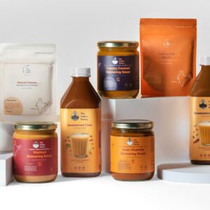 A variety of Indian spices, masalas, and flavorful sauces displayed on a white background showcasing authentic Indian cooking ingredients.
