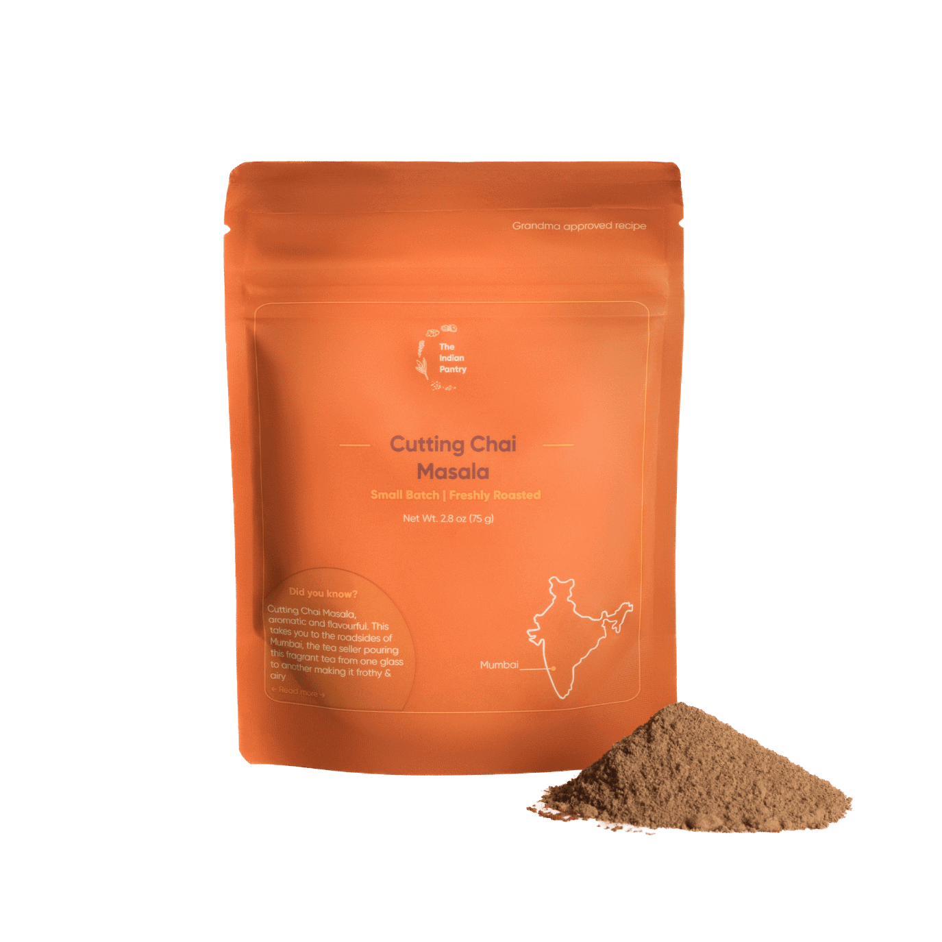 Alt text: A vibrant orange package of The Indian Pantry's Cutting Chai Masala, showcasing freshly roasted Indian spice blend perfect for authentic chai preparation, with a small pile of ground spices beside it.