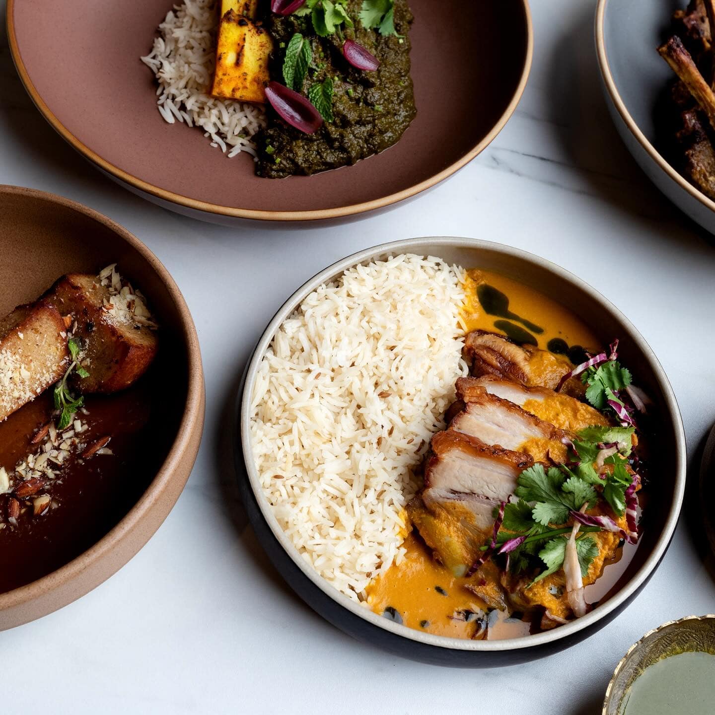 Delicious Indian dishes served with fragrant rice and flavorful curries, showcasing authentic spices and vibrant presentation for a traditional Indian Pantry experience.