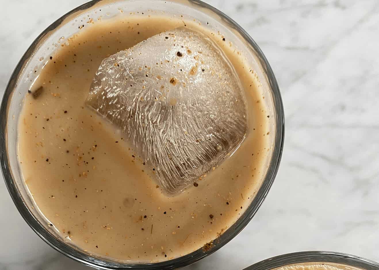Delicious Indian-style milk tea with ice and spices, served chilled, perfect for refreshment and authentic taste of Indian beverages.